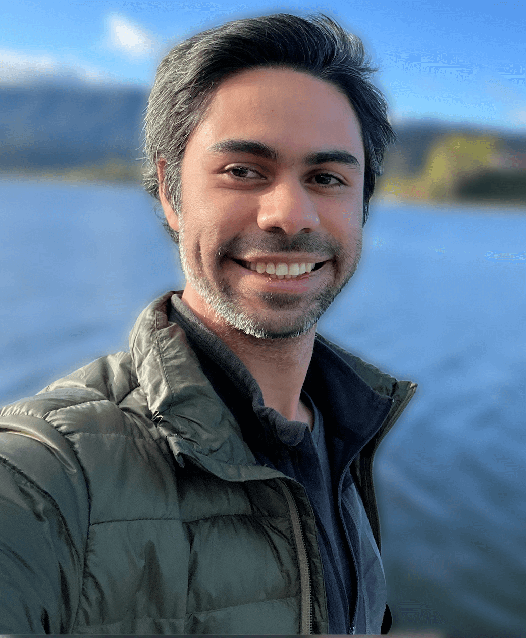 Felipe at a lake smiling